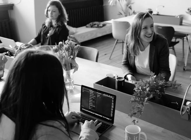 Three women working in open office setting